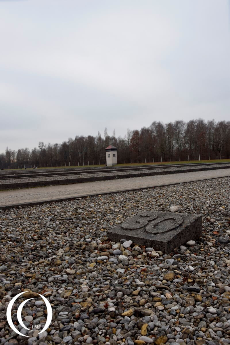 Dachau had 32 barracks, the outlines can been seen with a guard tower in the back